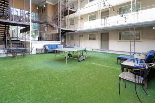 Ping pong table blue sofa outdoor seating exterior at Bountiful Court Apartments in Provo Student Accommodation