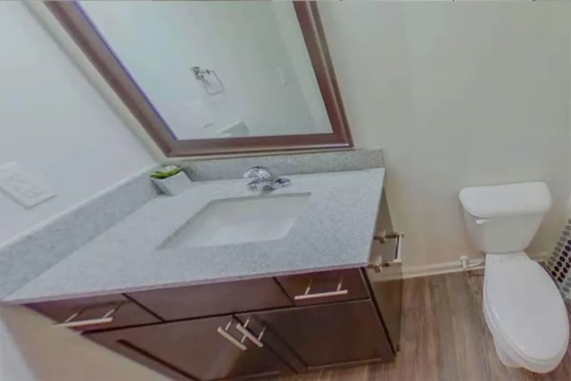 Vanity sink with mirror and toilet bathroom at The Edge at Conway in Conway Student Accommodation