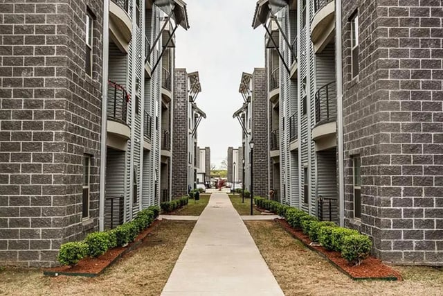 Sidewalk between brick buildings with balconies exterior at The Edge at Conway in Conway Student Accommodation