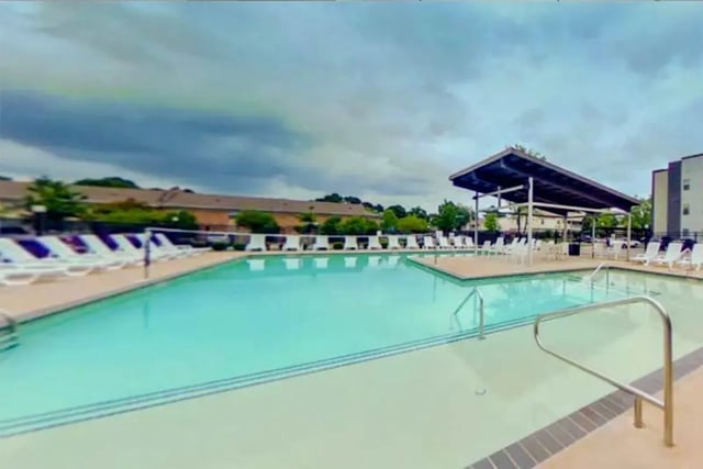 Swimming pool with lounge chairs and covered seating area exterior at The Edge at Conway in Conway Student Accommodation