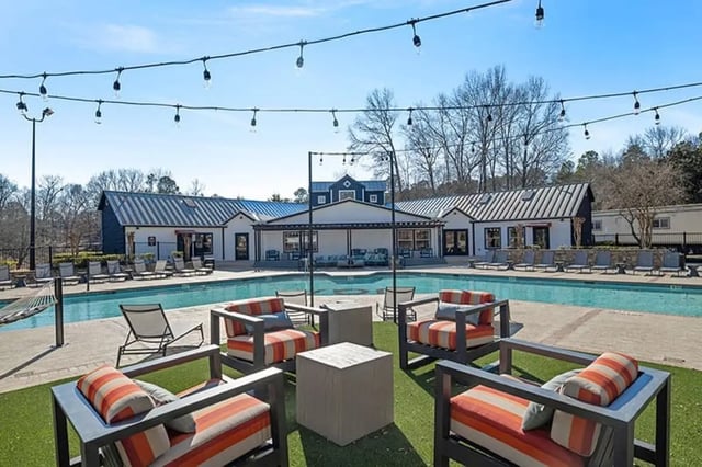 Outdoor lounge chairs and pool exterior at Arches On The Lake Student Living in Athens Student Accommodation