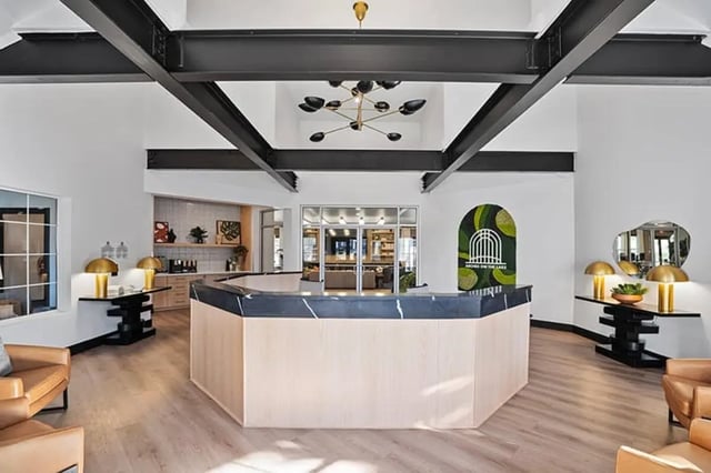 Reception desk with seating and modern chandelier lobby at Arches On The Lake Student Living in Athens Student Accommodation
