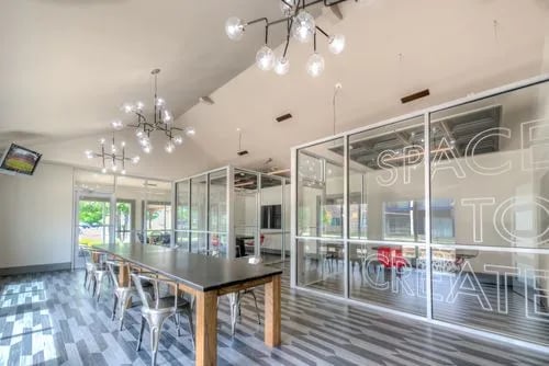 Large table chairs glass walls modern common area at The Reserve San Antonio in San Antonio Student Accommodation