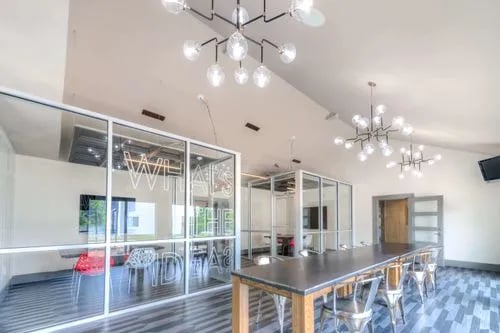 Glass-walled study area with long table and chairs study area at The Reserve San Antonio in San Antonio Student Accommodation