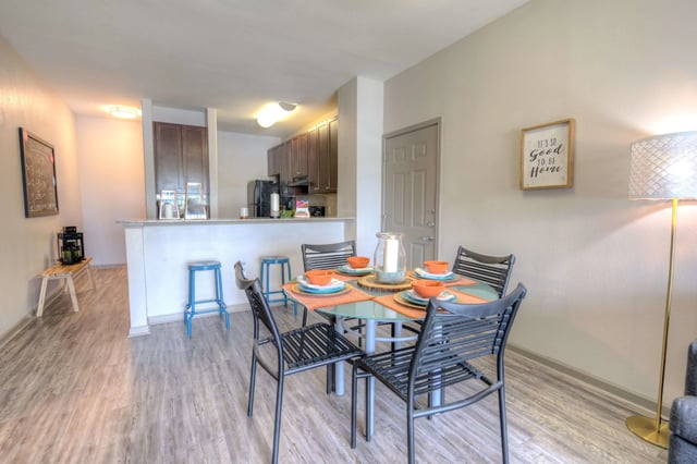 Dining table chairs chalkboard kitchen counter living area at The Reserve San Antonio in San Antonio Student Accommodation
