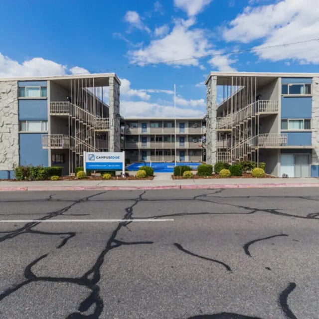 Blue apartment buildings with staircases and pool exterior at Campus Way in Provo Student Accommodation
