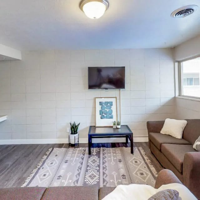 Brown sofas coffee table framed art living room at Campus Way in Provo Student Accommodation