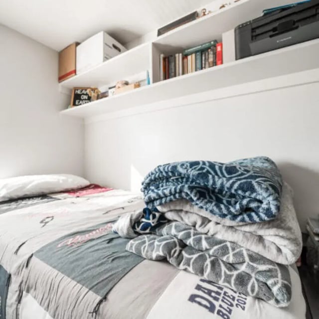 Bed with blankets shelves and printer bedroom at Campus Way in Provo Student Accommodation