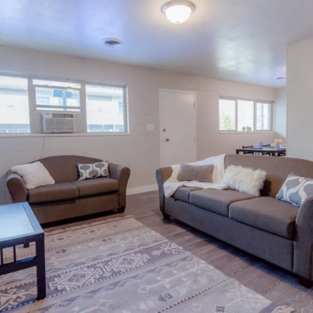 Two sofas patterned rug and coffee table Living room at Campus Way in Provo Student Accommodation