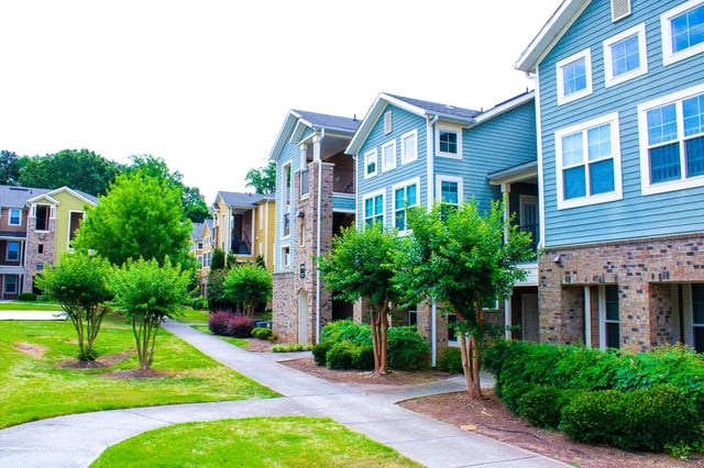 Apartment buildings with blue siding and brick exterior exterior at The Letterman Greensboro in Greensboro Student Accommodation