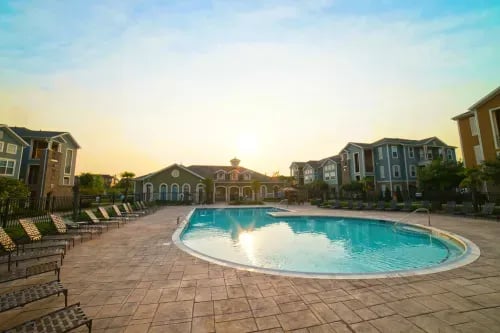 Apartment buildings surrounding pool and lounge chairs exterior at The Letterman Greensboro in Greensboro Student Accommodation