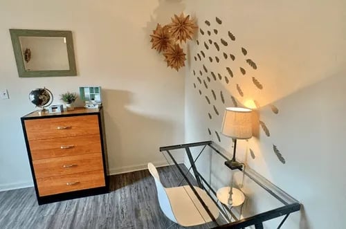 Dresser mirror globe lamp chair study area at Bradford Oaks Apartments in Tallahassee Student Accommodation