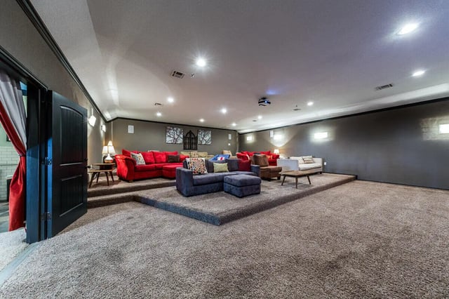 Sofa seating projector and coffee table living room at The Reserve at College Station in College Station Student Accommodation