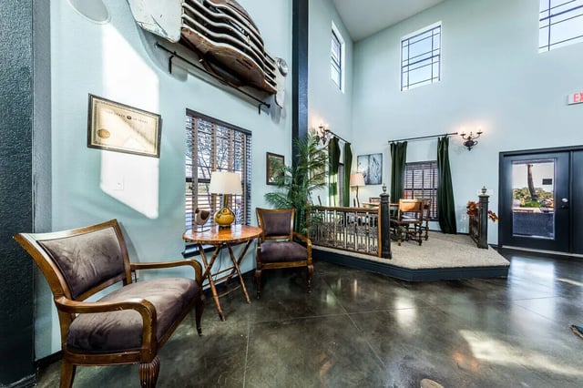 Chairs table lamp antique car grille living area at The Reserve at College Station in College Station Student Accommodation