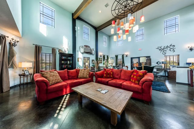 Red couches and wooden coffee table common area at The Reserve at College Station in College Station Student Accommodation