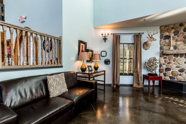 Leather sofa railing two lamps fireplace living room at The Reserve at College Station in College Station Student Accommodation