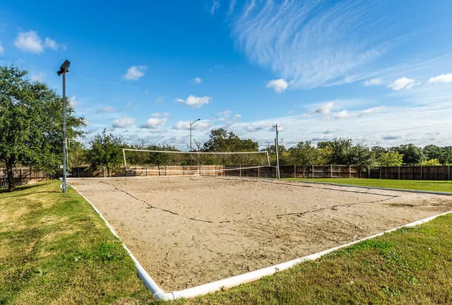 Volleyball court with sand and net exterior at The Reserve at College Station in College Station Student Accommodation