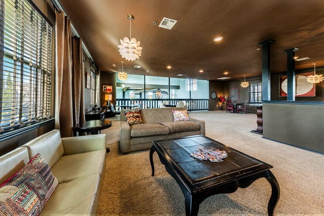 Sofa two coffee tables and lamps living room at The Reserve at College Station in College Station Student Accommodation