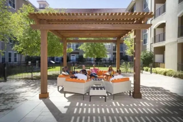 Students lounging on orange outdoor seating exterior at The Centre Suites in Lubbock Student Accommodation