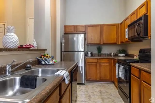Stainless steel refrigerator wooden cabinets kitchen at The Centre Suites in Lubbock Student Accommodation