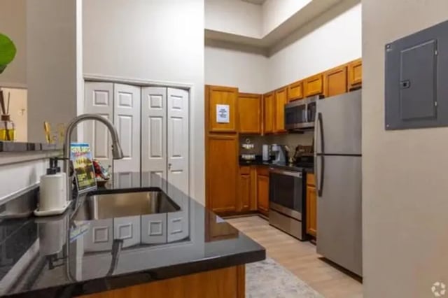 Kitchen with cabinets sink faucet refrigerator oven appliances kitchen at The Centre Suites in Lubbock Student Accommodation