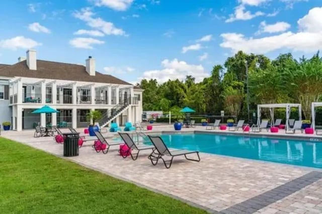 Pool with lounge chairs and building exterior at Arden Villas in Orlando Student Accommodation
