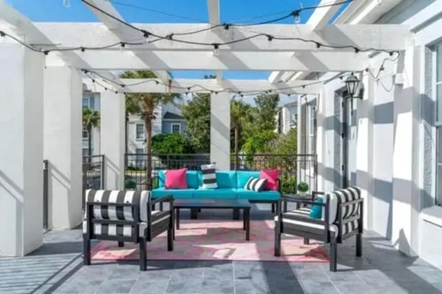 Turquoise sofa striped chairs outdoor seating area at Arden Villas in Orlando Student Accommodation