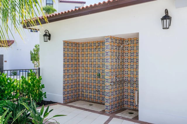 Outdoor tiled showers with two showerheads exterior at The Residences at University Village in Fort Myers Student Accommodation