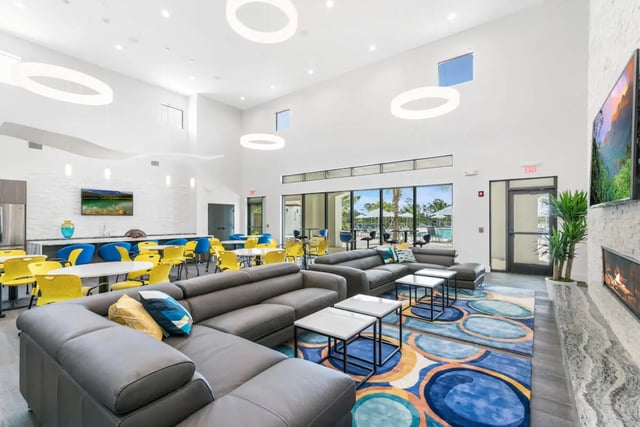 Sofa tables lounge area with colorful rug living room at The Residences at University Village in Fort Myers Student Accommodation