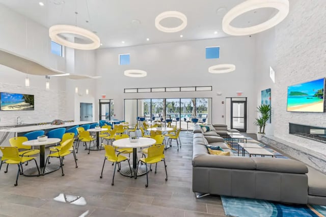 Comfortable seating areas tables and chairs common room at The Residences at University Village in Fort Myers Student Accommodation