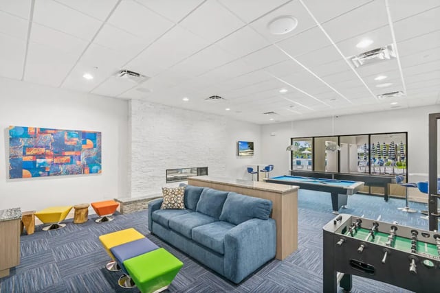 Sofa pool table foosball table living room at The Residences at University Village in Fort Myers Student Accommodation