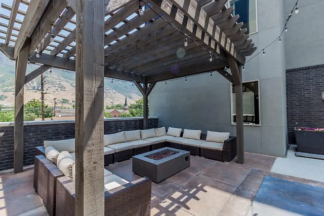 Outdoor lounge with sectional sofa fire pit exterior at CollegePlace Provo in Provo Student Accommodation