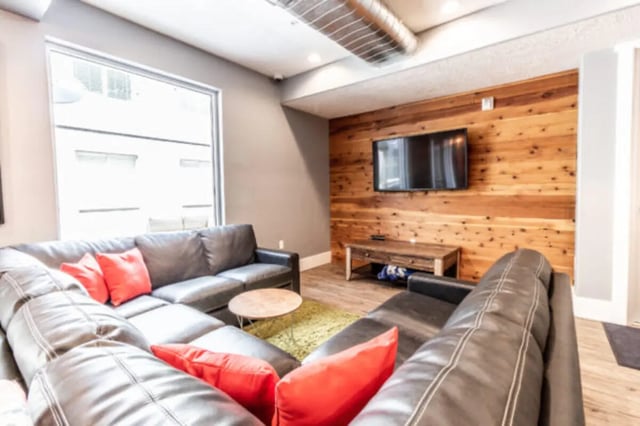 Leather sectional sofa with red pillows living room at CollegePlace Provo in Provo Student Accommodation