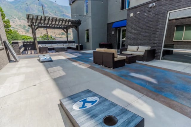 Cornhole games under pergola and seating area exterior at CollegePlace Provo in Provo Student Accommodation