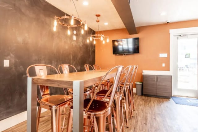 Large table copper chairs tv communal space at CollegePlace Provo in Provo Student Accommodation