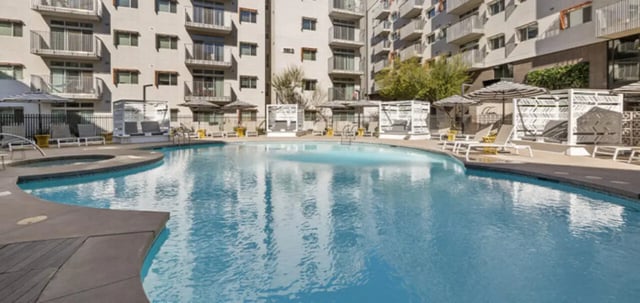 Pool with cabanas and lounge chairs exterior at Vertex Apartments in Tallahassee Student Accommodation