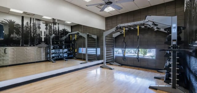 Gym equipment weights and mirrored wall gym area at The Vista in Turlock Student Accommodation
