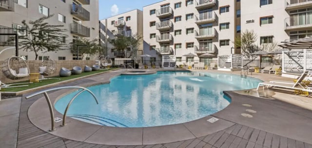 Pool lounge chairs and hanging chairs exterior at The Vista in Turlock Student Accommodation