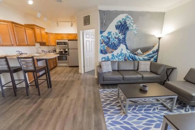 Sofa coffee table kitchen counters island living room at CollegePlace Uptown