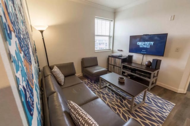Leather sectional couch coffee table and television living room at CollegePlace Uptown