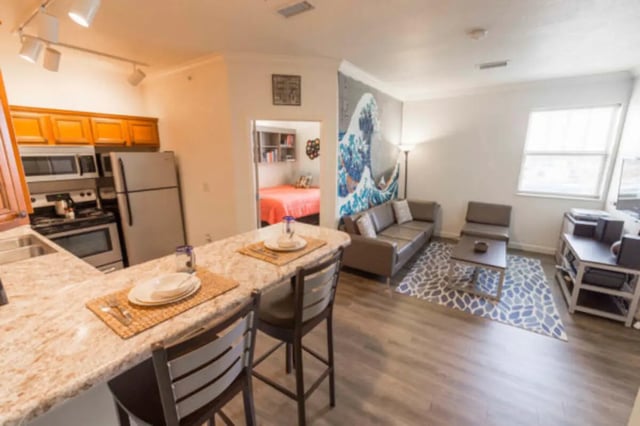 Kitchen island, sofa, coffee table, bedroom area living room at CollegePlace Uptown