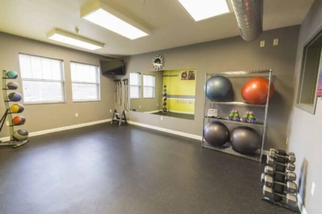 Exercise equipment on shelves and floor Fitness room at CollegePlace Uptown