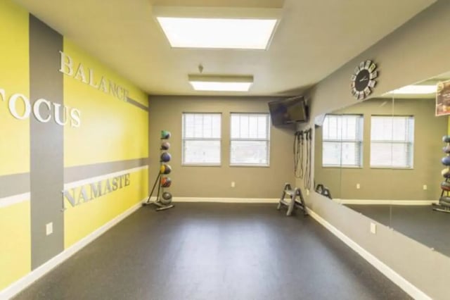Gym with weights and mirrors fitness area at CollegePlace Uptown