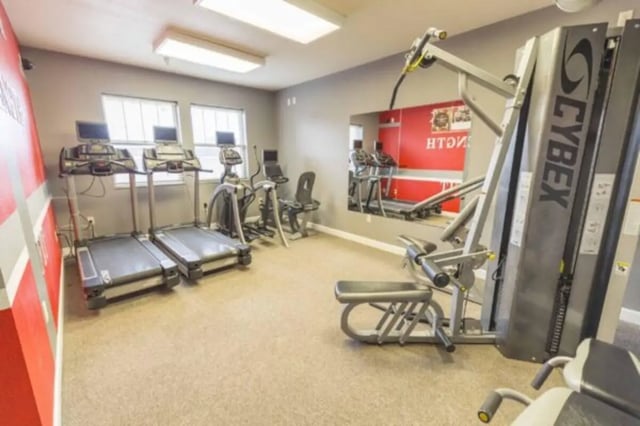 Treadmills elliptical and weight machine gym room at CollegePlace Uptown