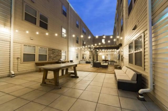 Courtyard with string lights couch and table exterior at CollegePlace Uptown