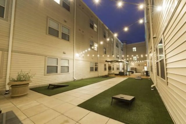 Courtyard with string lights and cornhole games Exterior at CollegePlace Uptown