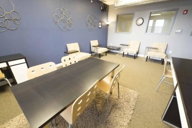 Study tables and chairs with decorative wall art Common area at CollegePlace Uptown