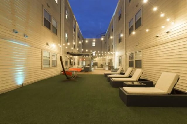 Courtyard with lounge chairs and string lights exterior at CollegePlace Uptown