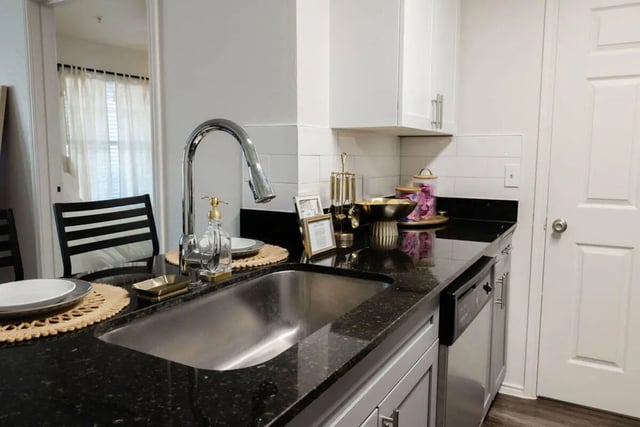 Stainless steel sink and granite countertop kitchen at The Lodge Apartments in San Marcos Student Accommodation