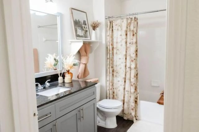 Sink toilet and shower with floral curtain bathroom at The Lodge Apartments in San Marcos Student Accommodation